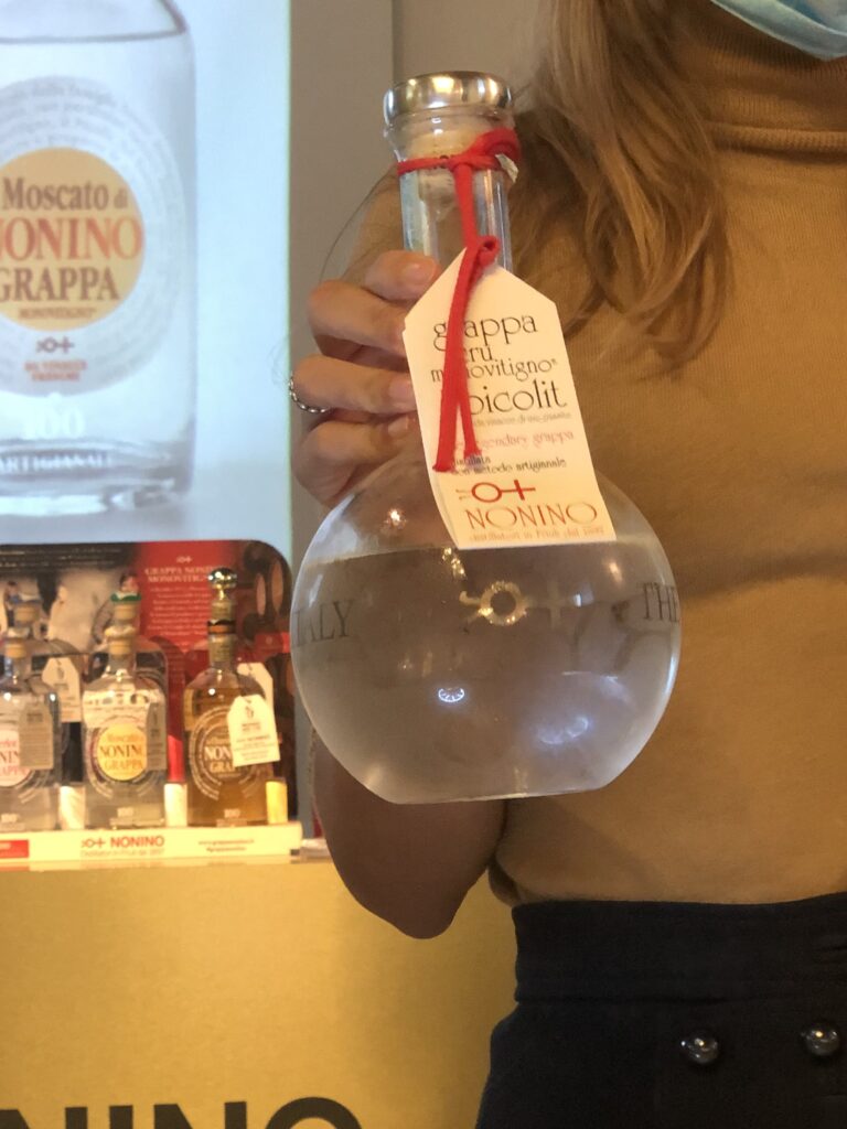 Francesca Nonino holding the “perfume bottle” grappa monovitigno Picolit